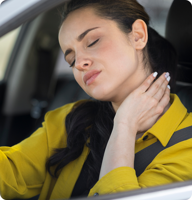 Woman in a car holding her neck in pain after an accident